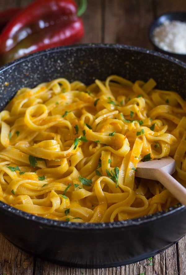 creamy red pepper sauce in a black pan with fettuccine