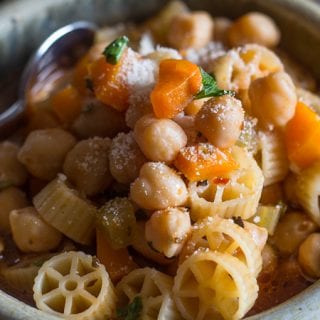 chickpea soup in a bowl with parmesan cheese