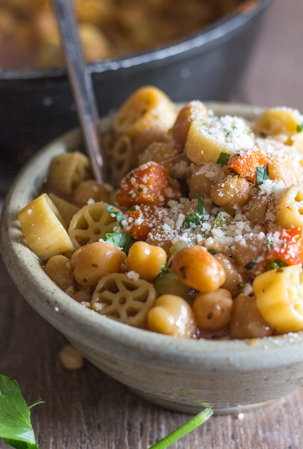 cooked chickpea soup in a bowl with parmesan cheese