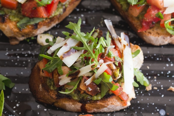 up close slice of bruschetta on a black grill pan