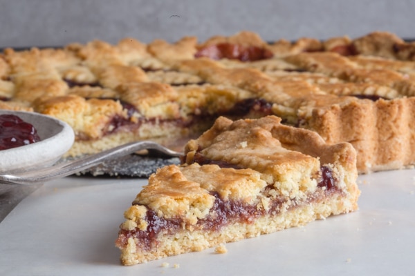 a slice of crostata on a white paper