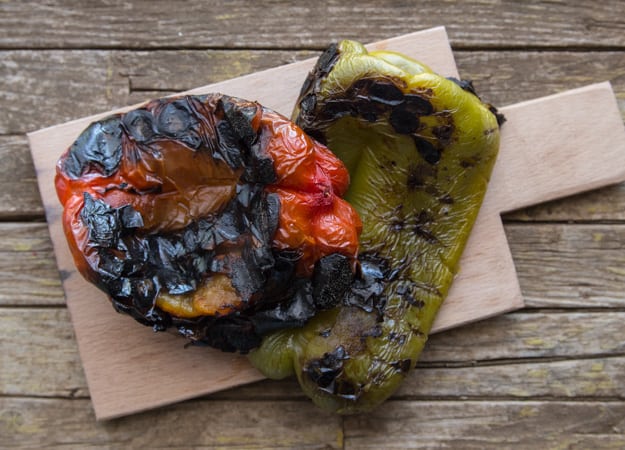 burnt peppers on a wooden board