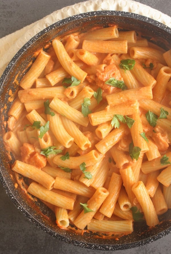 cream sauce with rigatoni pasta in a black pan