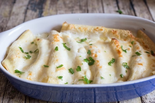 crepe cannelloni in a blue pan baked
