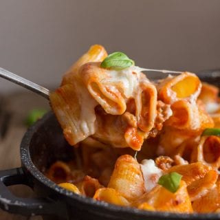 a spoon of baked pasta from the pan