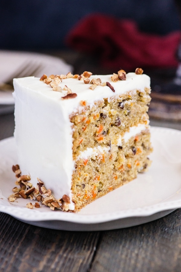 a slice of carrot cake on a white plate