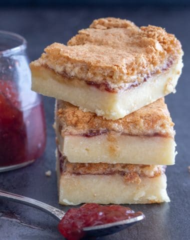 3 coconut jam squares stacked.
