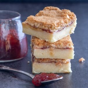 3 coconut jam squares stacked.