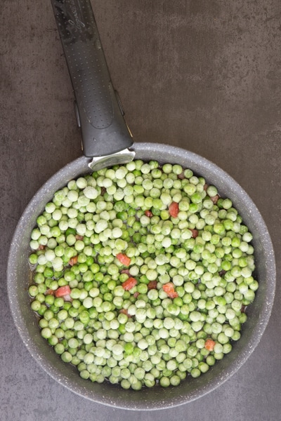 peas, pancetta and water in a pan to be cooked