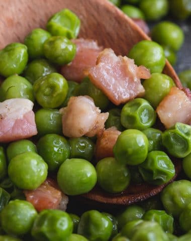 peas and pancetta on a wooden spoon