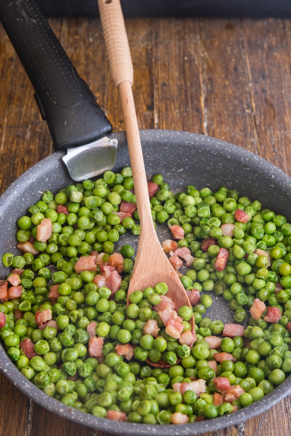 peas and pancetta in a pan cooked