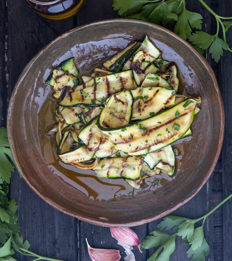 Grilled zucchini on a brown dish.