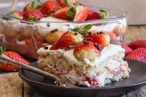 slice of strawberry tiramisu on a black plate