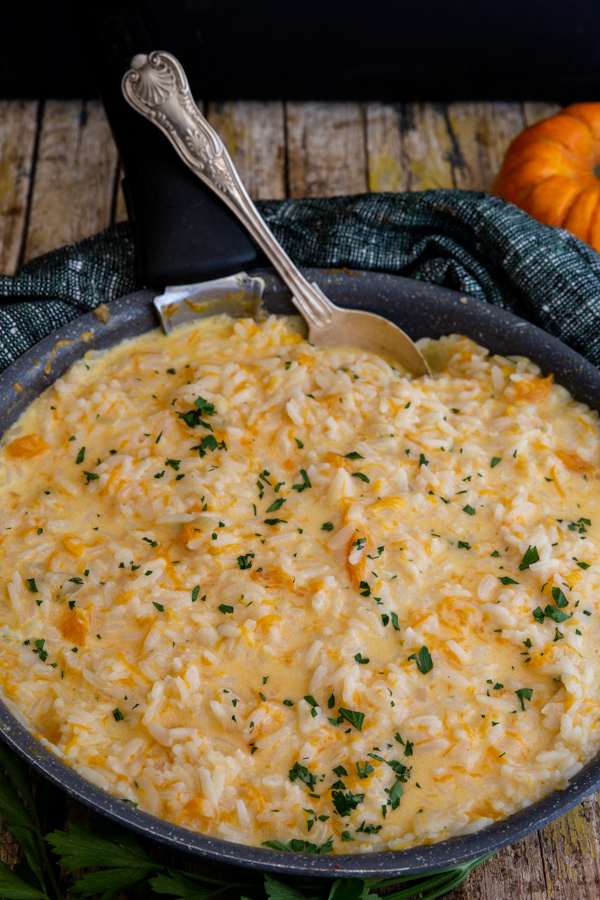 pumpkin risotto in a black pan.