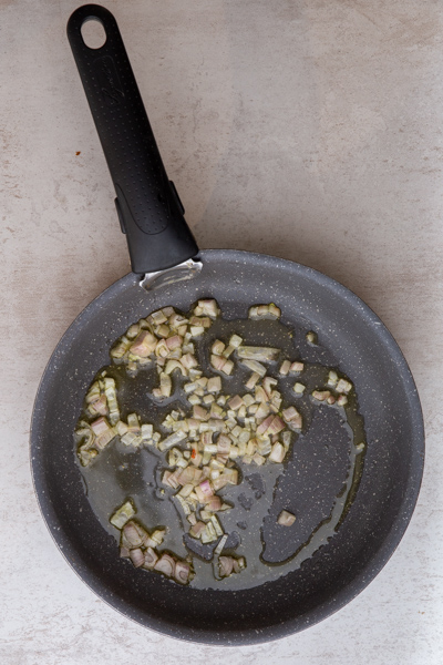 Onion in a pan cooked until transparent.