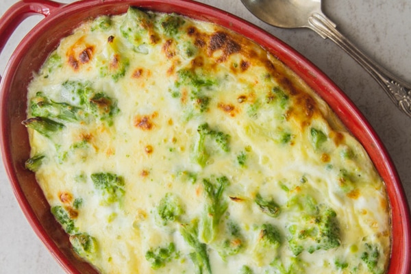 broccoli casserole in a red baking dish
