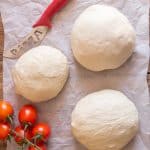 pizza dough 3 rounds on parchment paper