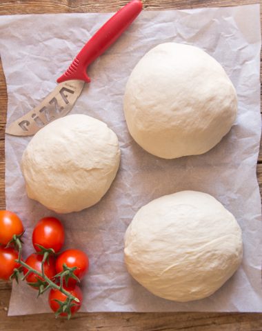 pizza dough 3 rounds on parchment paper