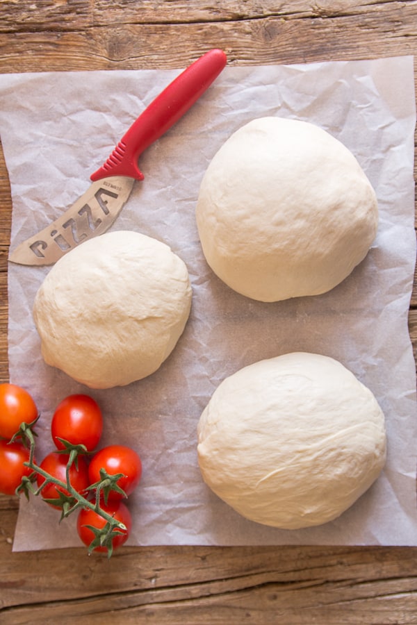 pizza dough 3 rounds on parchment paper