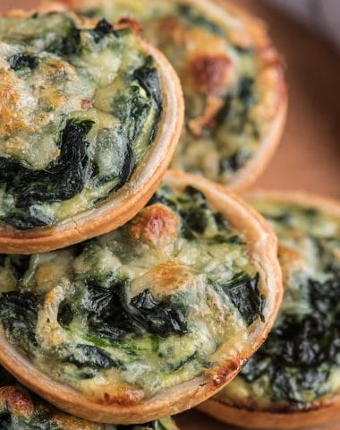Ricotta spinach tarts on a white plate.