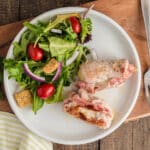The pork on a plate with salad.
