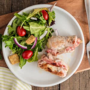 The pork on a plate with salad.