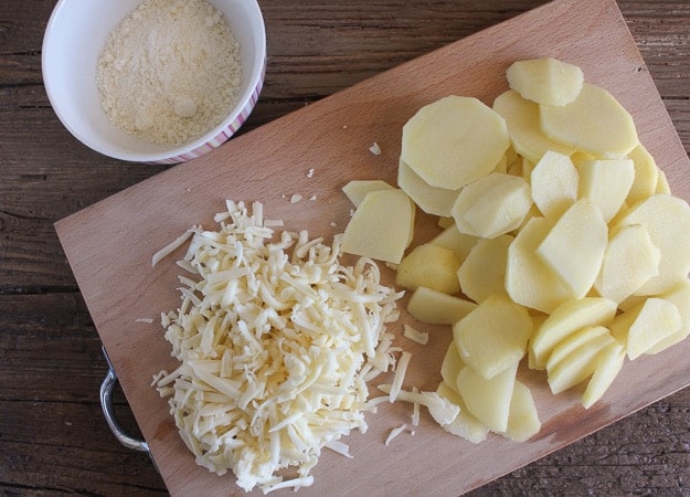 shredded cheese, parmesan and sliced potatoes for scalloped potato recipe