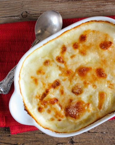 scalloped potatoes baked in a white pan