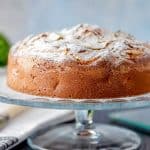 Pear cake on a glass cake stand.