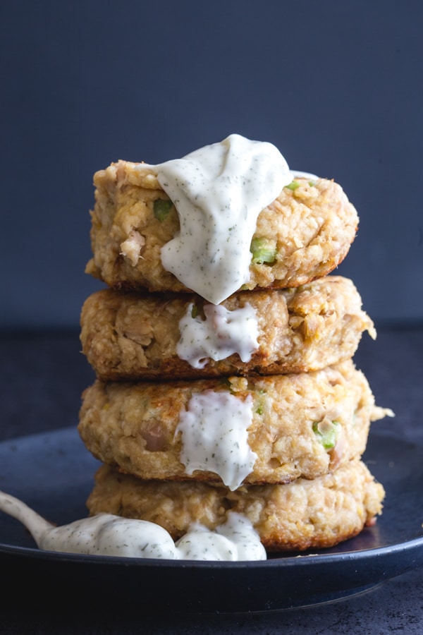 stacked tuna burgers with dill sauce dripping down