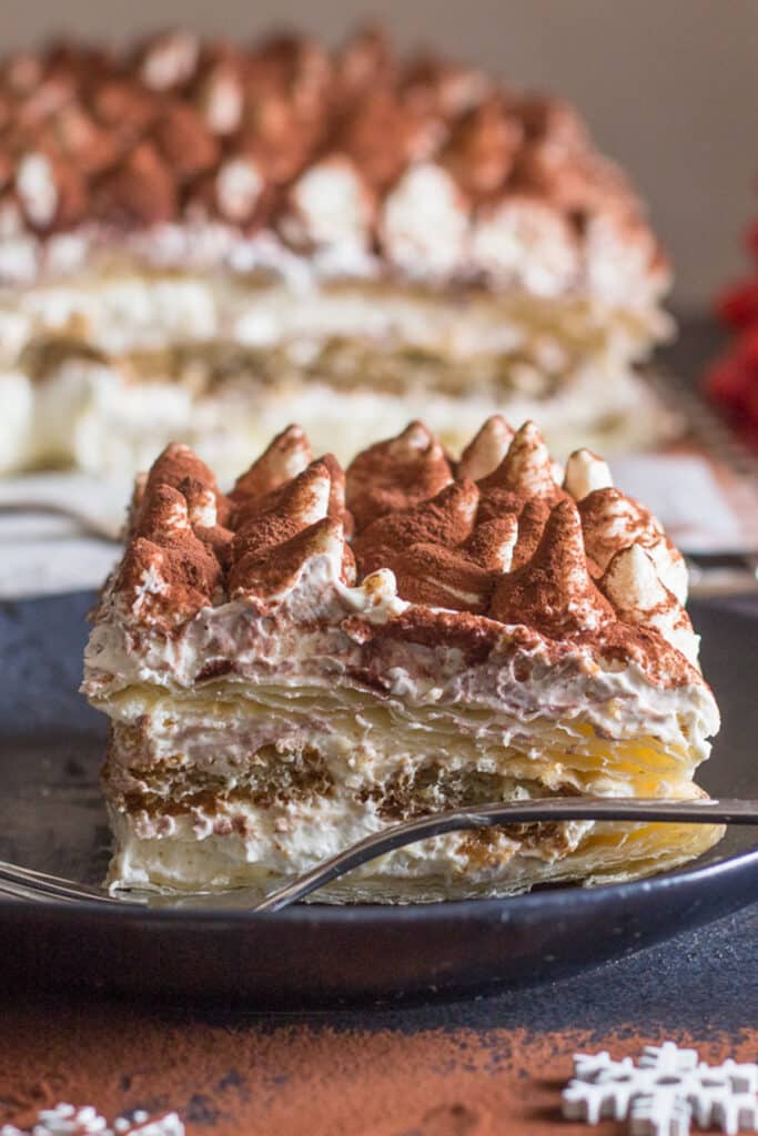 Tiramisu puff pastry in a black dish.