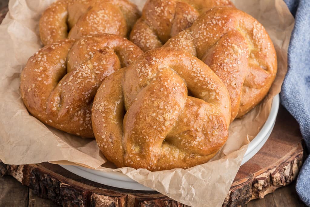 Pretzels in a bowl lined with brown paper.