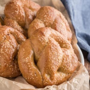 Pretzels in a bowl lined with brown paper.