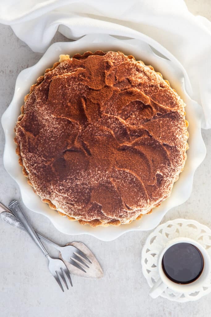 Tiramisu pie on a white board.