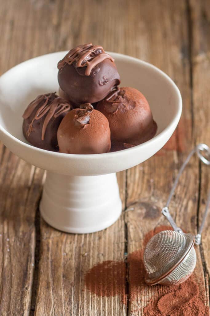 Tiramisu truffles on a white dish.