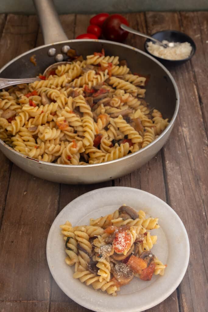 Fusilli pasta in the pan and on a plate.