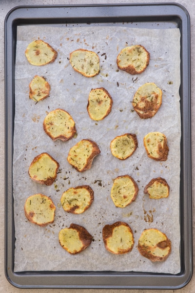 Baked potato chips on a cookie sheet.