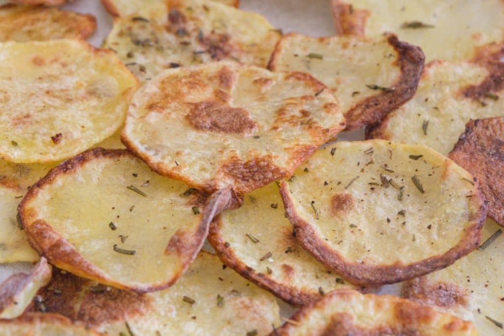 Baked potato chips on a cookie sheet.