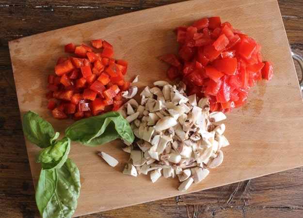 Chopped veggies on a wooden board.