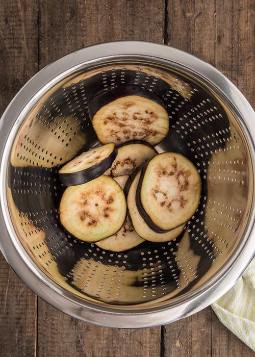 Eggplant in a bowl with salt.