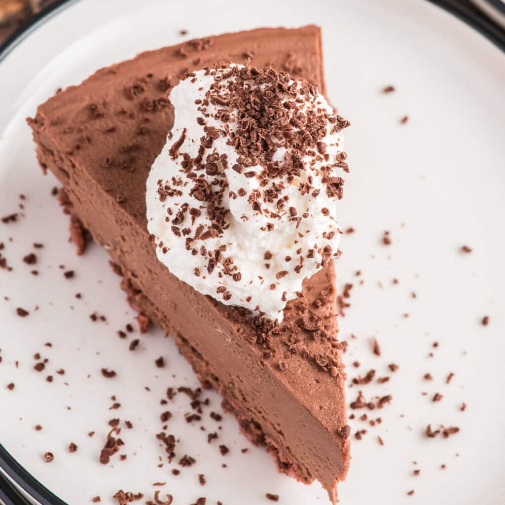 A slice of frozen pie on a white plate.