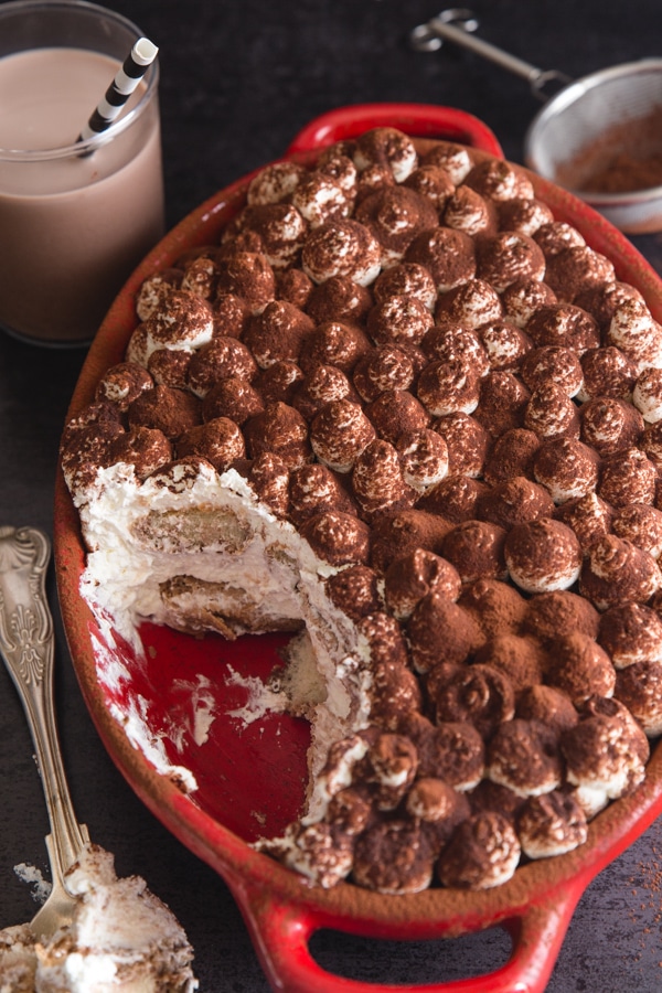 easy tiramisu in a red pan with a spoonful 