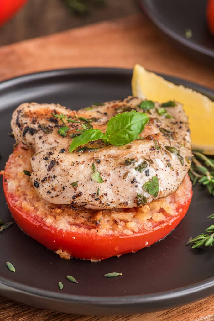 Grilled chicken on a breaded tomato.