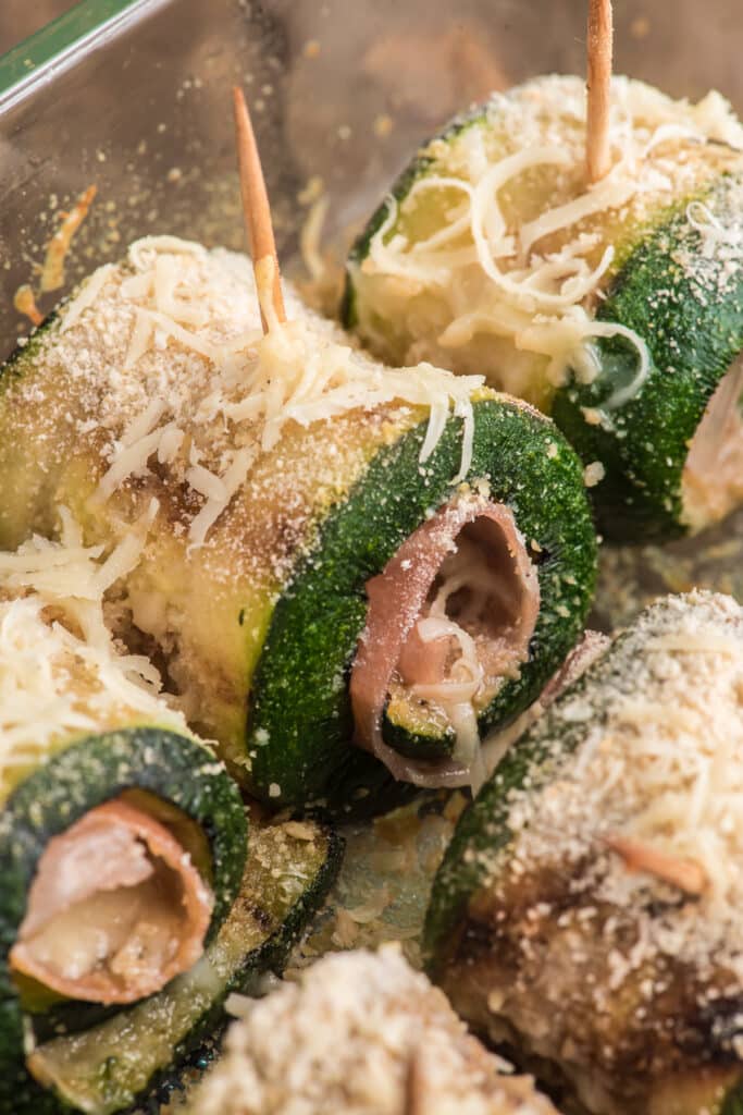 Zucchini rollups in a glass dish.