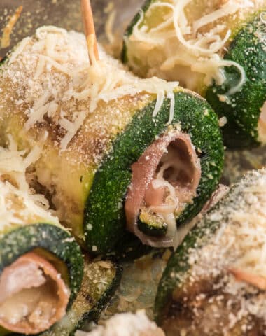 Zucchini rollups in a glass dish.