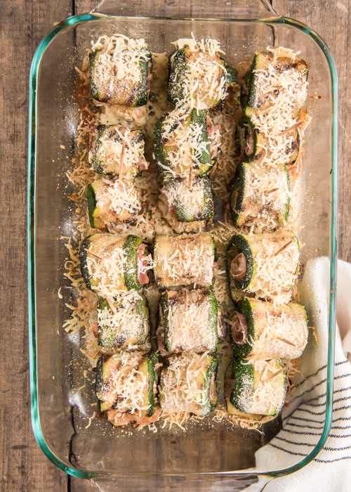 Zucchini rollups baked in a glass dish.