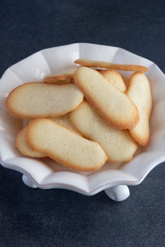 Flat cookies on a white plate.
