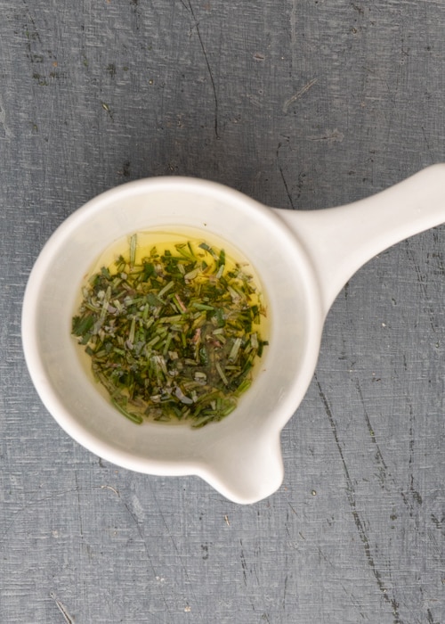 Mixing the rosemary and oil in a small bowl.