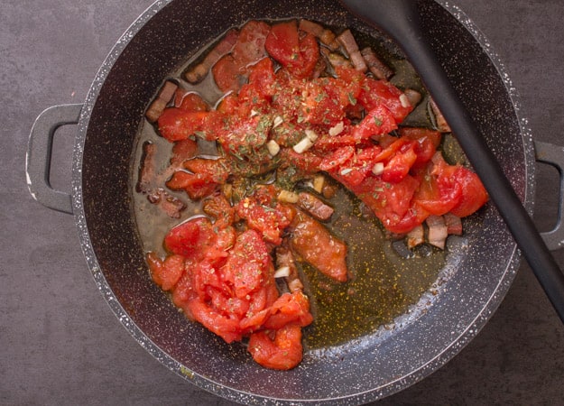 fresh tomatoes, pancetta and olive oil in a pan