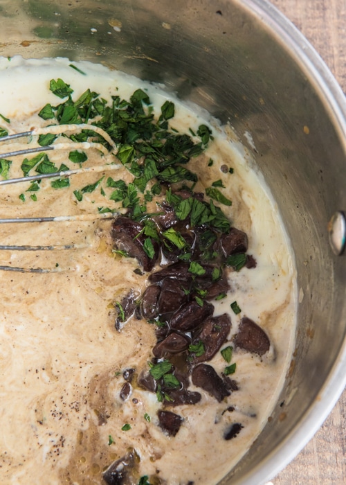 Adding the blended mushroom mixture and parsley.